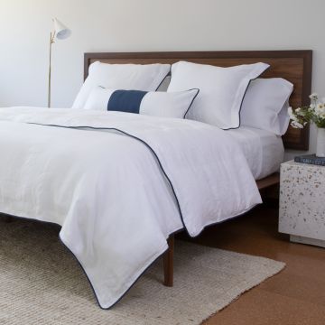Huddleson navy and white bedding. White Linen Duvet Cover and pillow shams with Navy Trim Piped Edge