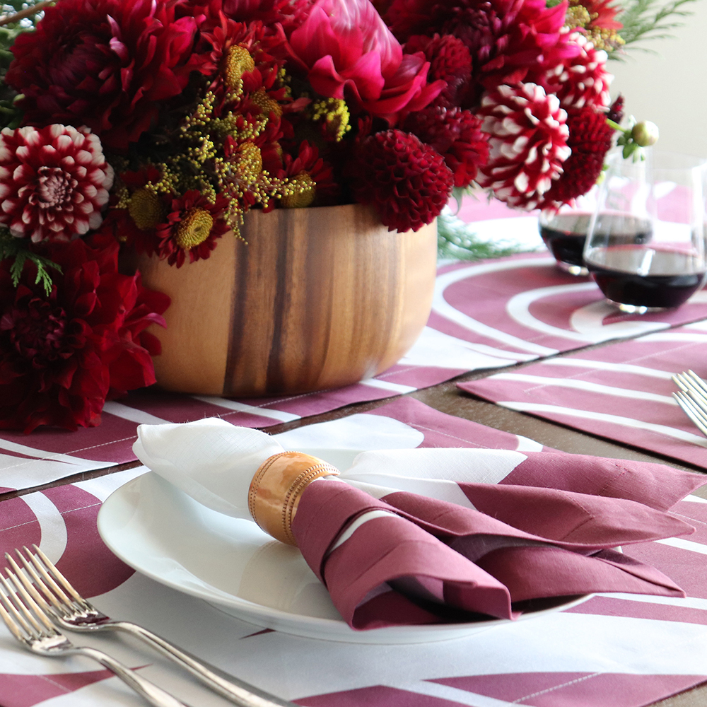 White linen napkin claret red border Christmas table